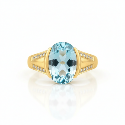 Gold ring with a blue gemstone on a white background