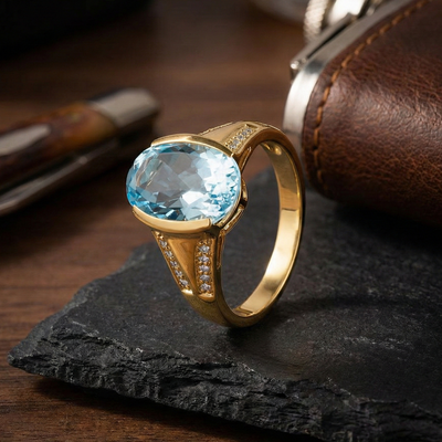 Gold ring with a blue gemstone on a dark surface