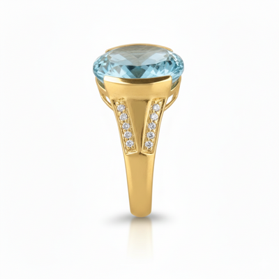Gold ring with a blue gemstone on a white background
