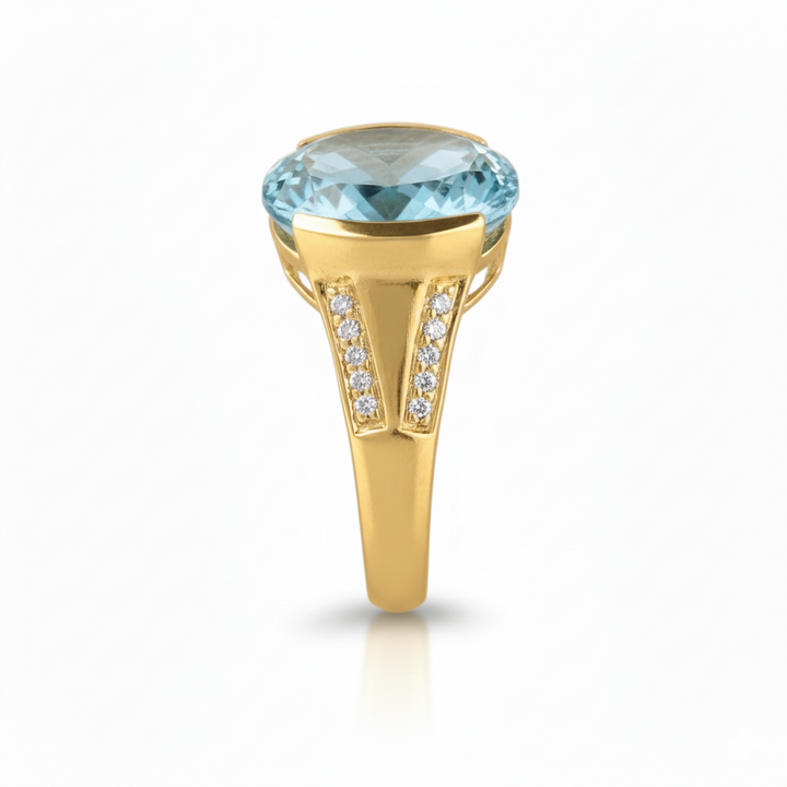 Gold ring with a blue gemstone on a white background