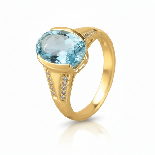 Gold ring with a blue gemstone on a white background