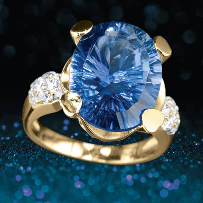 Azure Ring featuring a large blue gemstone set in sterling silver with gold plating, designed for women, accented by small sparkling stones on the band.