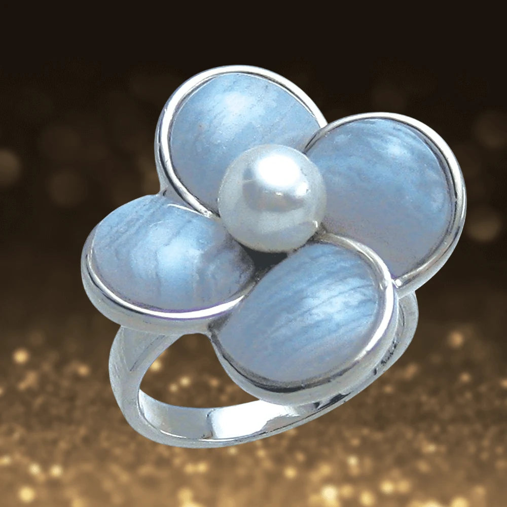 Lace Agate Ring for female featuring a silver band with a four-petal flower design of soft blue lace agate stones and a central white pearl, elegant jewelry piece.