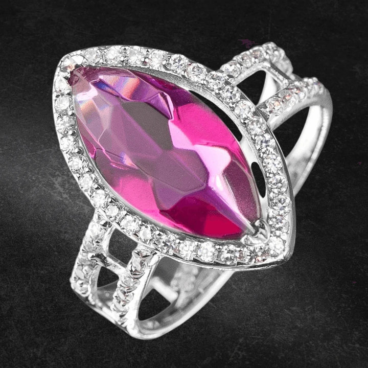 Close-up of the Riva Ring featuring a marquise-shaped pink gemstone surrounded by sterling silver and rhodium-plated band adorned with small sparkling stones, designed for women.