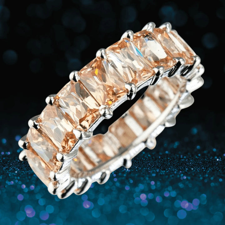 Champagne Forever Baguette Eternity Ring featuring rectangular champagne gemstones set in sterling silver with rhodium plating, designed for women’s jewelry collections.