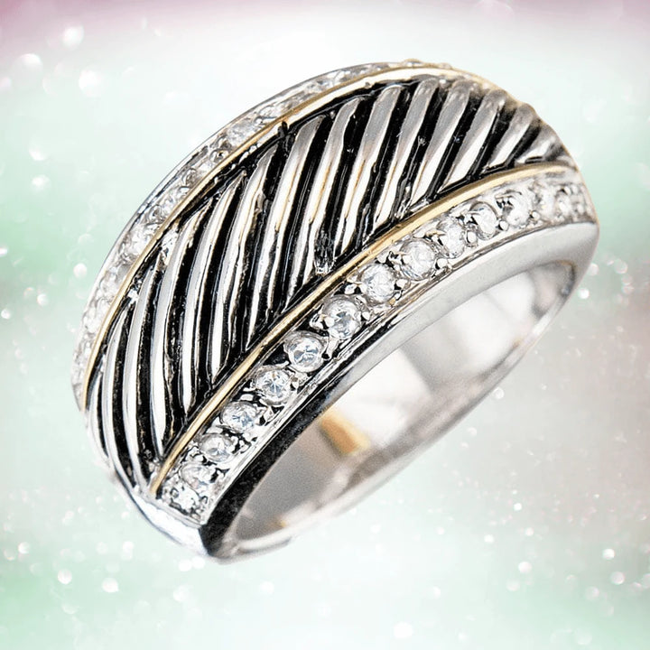 Monte Carlo Ring in sterling silver with two-tone plating, featuring diagonal textured lines and a row of clear gemstones, designed as unisex jewelry.