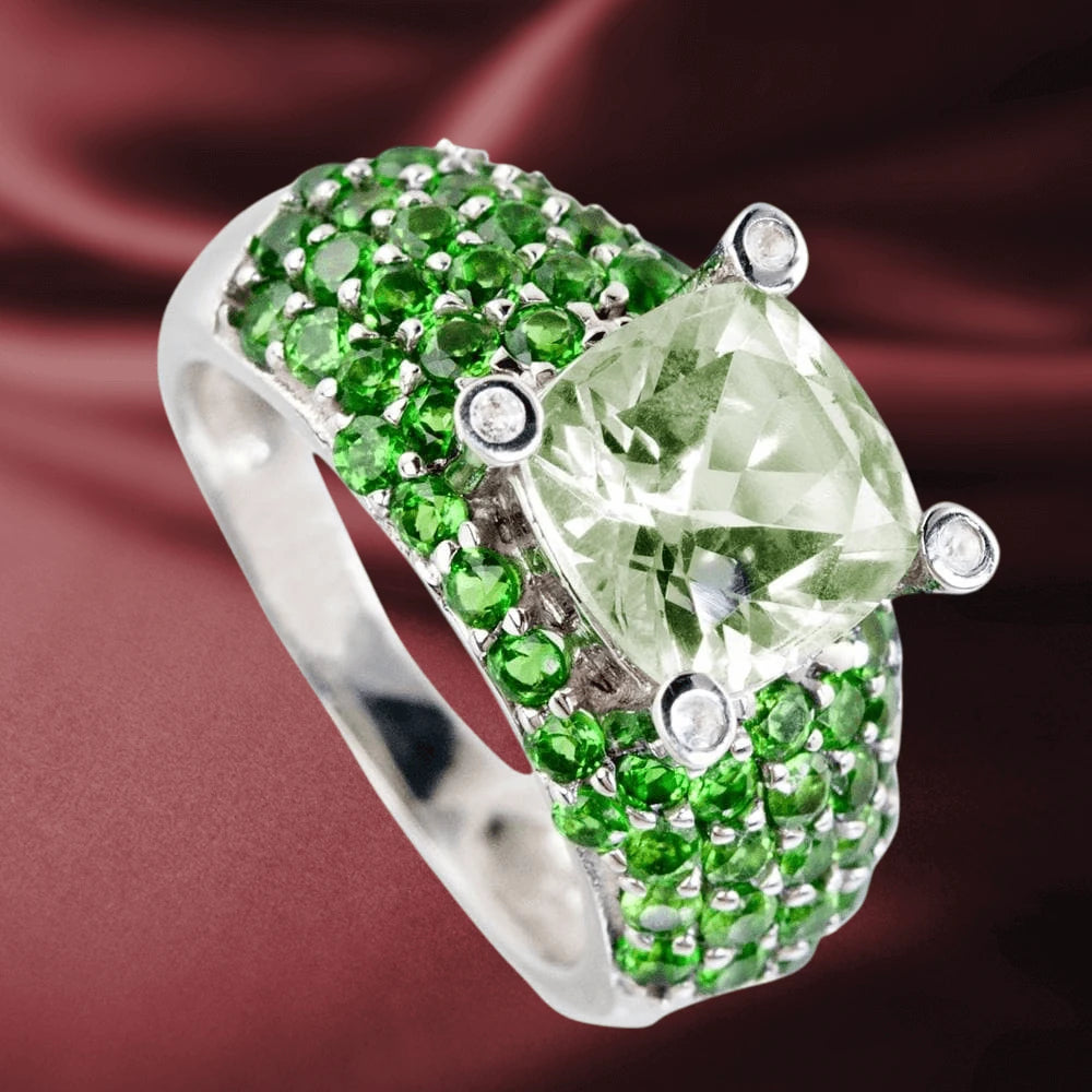 Apple Martini Ring featuring a large pale green center stone surrounded by multiple small vivid green stones set in sterling silver with rhodium plating for women’s jewelry.