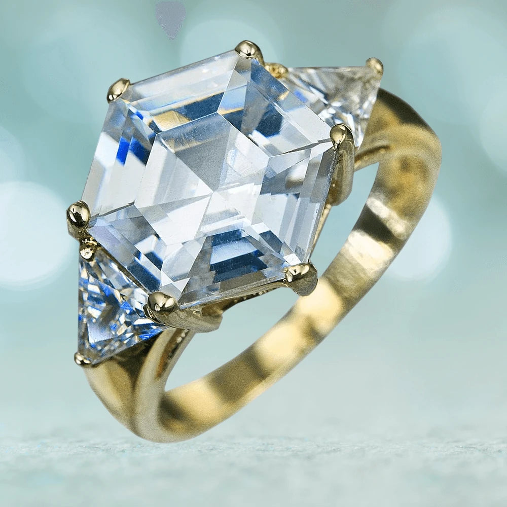 Hexa Ring featuring a sterling silver band with gold plating, showcasing a large hexagonal clear gemstone flanked by two triangular clear gemstones, designed for females.