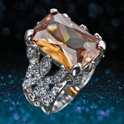 Honeysuckle Ring featuring a large rectangular amber gemstone set in sterling silver with rhodium plating, embellished with intricate floral-inspired detailing and sparkling accents.