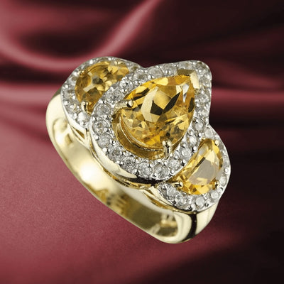 Golden Citrine Ring featuring three pear-shaped citrine stones set in sterling silver with gold plating, adorned with sparkling accents, designed for women’s jewelry collections.