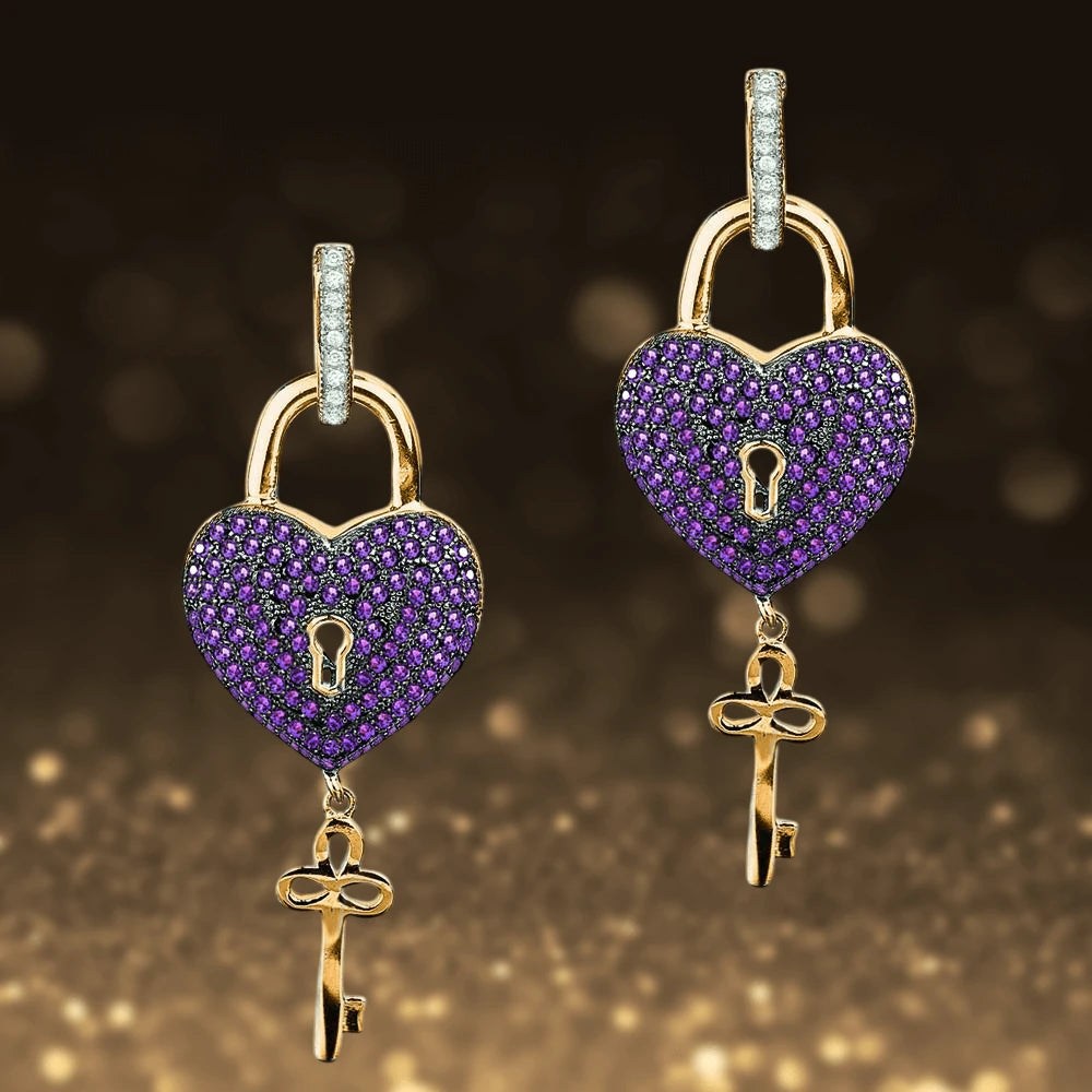 Paris Heart Earrings featuring sterling silver with gold plating, shaped as heart lockets adorned with purple stones and a dangling gold key, designed for women’s jewelry.