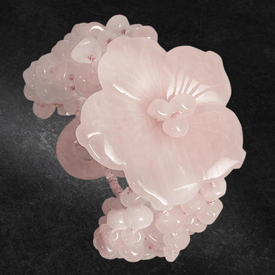 Cherry Blossom Bracelet featuring delicate pink gem beads and an intricately carved flower design, crafted as elegant female jewelry.