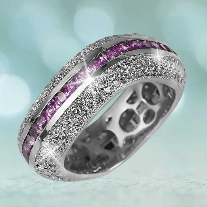 Palacio Silver Ring in sterling silver with rhodium plating, featuring sparkling clear stones and a row of vibrant purple gemstones, designed for women’s jewelry collections.