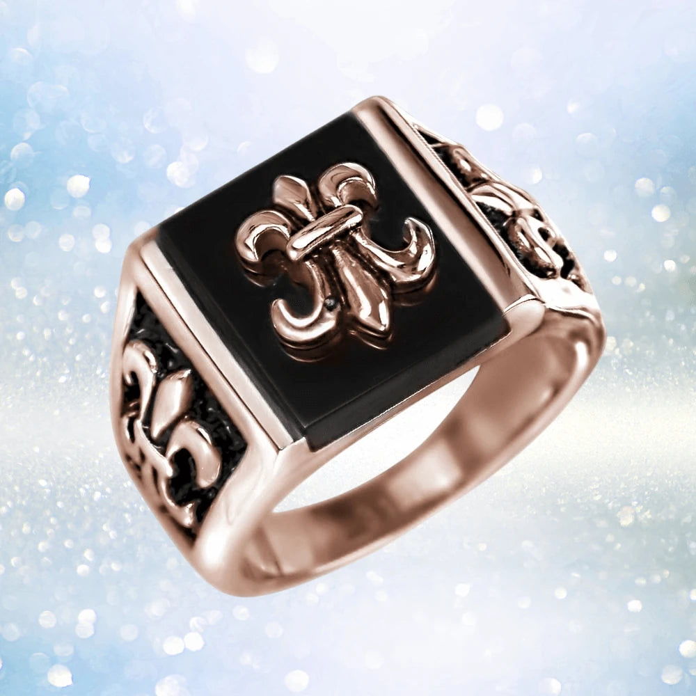 Grand Canyon Rose Gold Ring featuring a stainless steel band with rose gold plating and black inlay, decorated with elegant fleur-de-lis motifs for men’s jewelry.