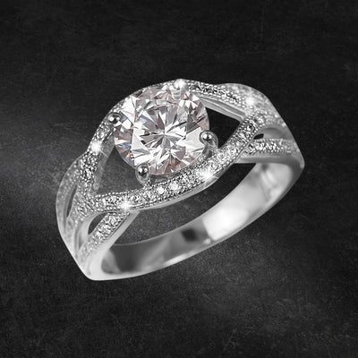 Astor Ring featuring a sparkling round center stone set in rhodium-plated sterling silver with intricate detailing, designed for women’s fine jewelry collection.