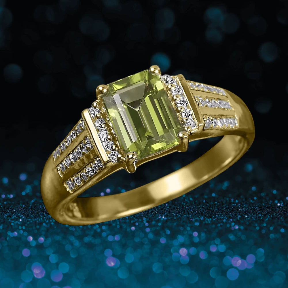 Augustine Peridot Ring featuring a sterling silver band with gold plating, showcasing a rectangular peridot center stone and accentuated by rows of small sparkling diamonds.