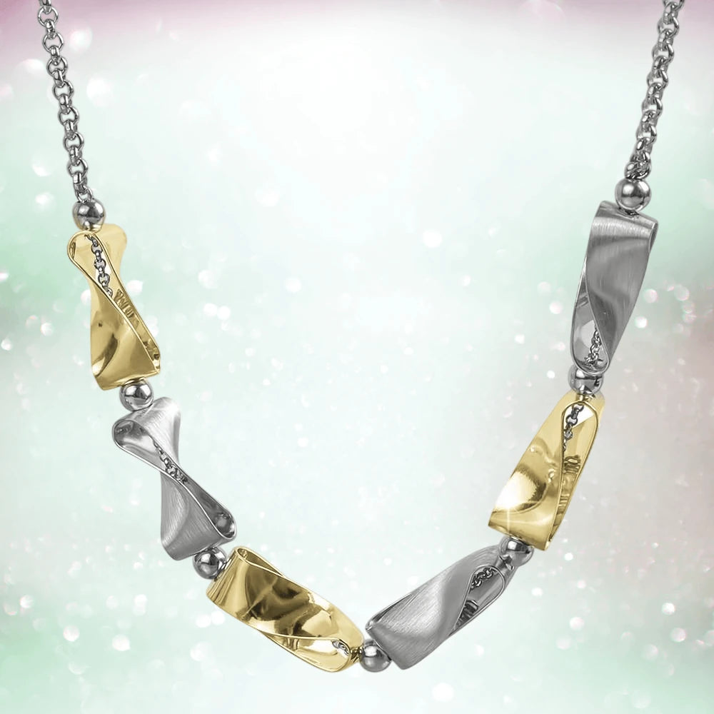Clementine Twist Necklace featuring two-tone sterling silver with a modern twist design, combining polished gold and silver tones for elegant women’s jewelry.