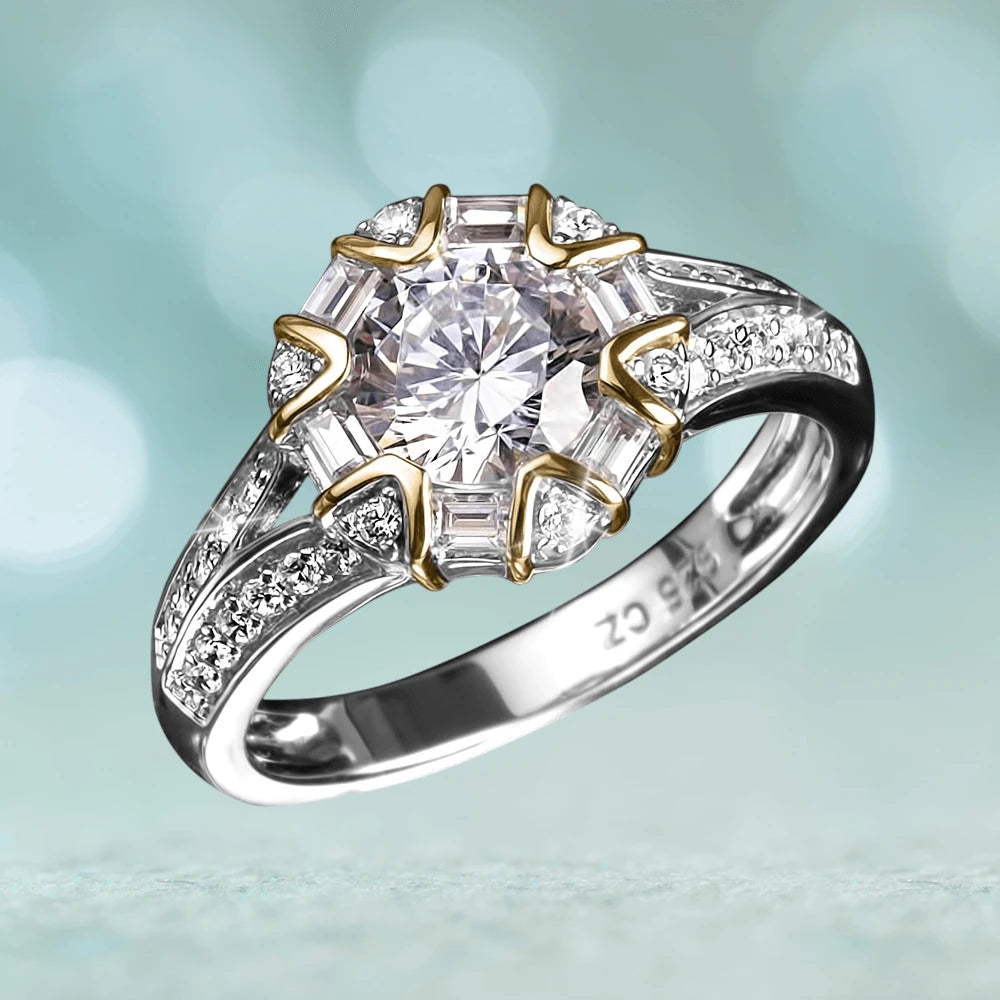 Ravella Ring crafted in sterling silver with two-tone plating, featuring a round central gemstone surrounded by baguette and smaller round stones, designed for women’s jewelry collection.