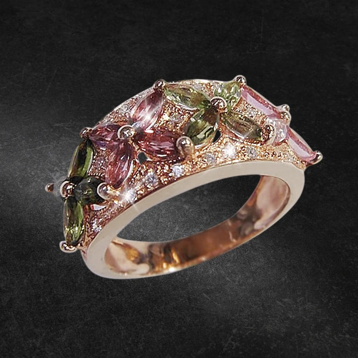 Tourmaline Fleur Ring crafted in sterling silver with rose gold plating, featuring pink and green tourmaline gemstones arranged in a floral design for women’s jewelry.