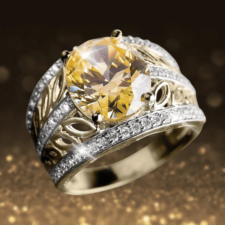 Golden Sahara Ring featuring a large faceted yellow gemstone set in sterling silver with gold plating, accented by intricate filigree and small clear stones, designed for women.
