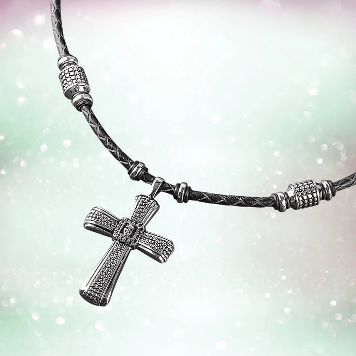 Midnight Skull Steel Pendant featuring a sterling silver cross pendant on a braided black leather necklace, designed for male jewelry enthusiasts.