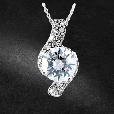 Sterling Silver Sonata Pendant featuring a large sparkling center stone surrounded by smaller accent stones on a delicate chain, designed for women’s jewelry collections.