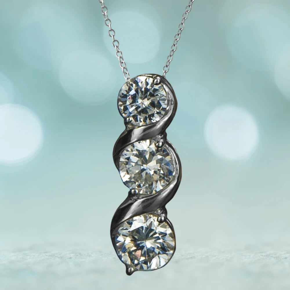 Solitaire Twist Pendant featuring three sparkling stones set in sterling silver with rhodium plating, designed for a sophisticated female jewelry collection.