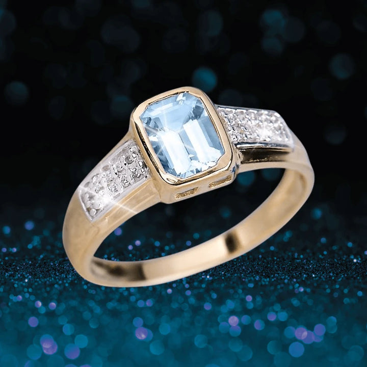 Oseaan Aquamarine Ring featuring a gold-plated sterling silver band with a rectangular aquamarine center stone and diamond accents, designed for women’s jewelry collection.