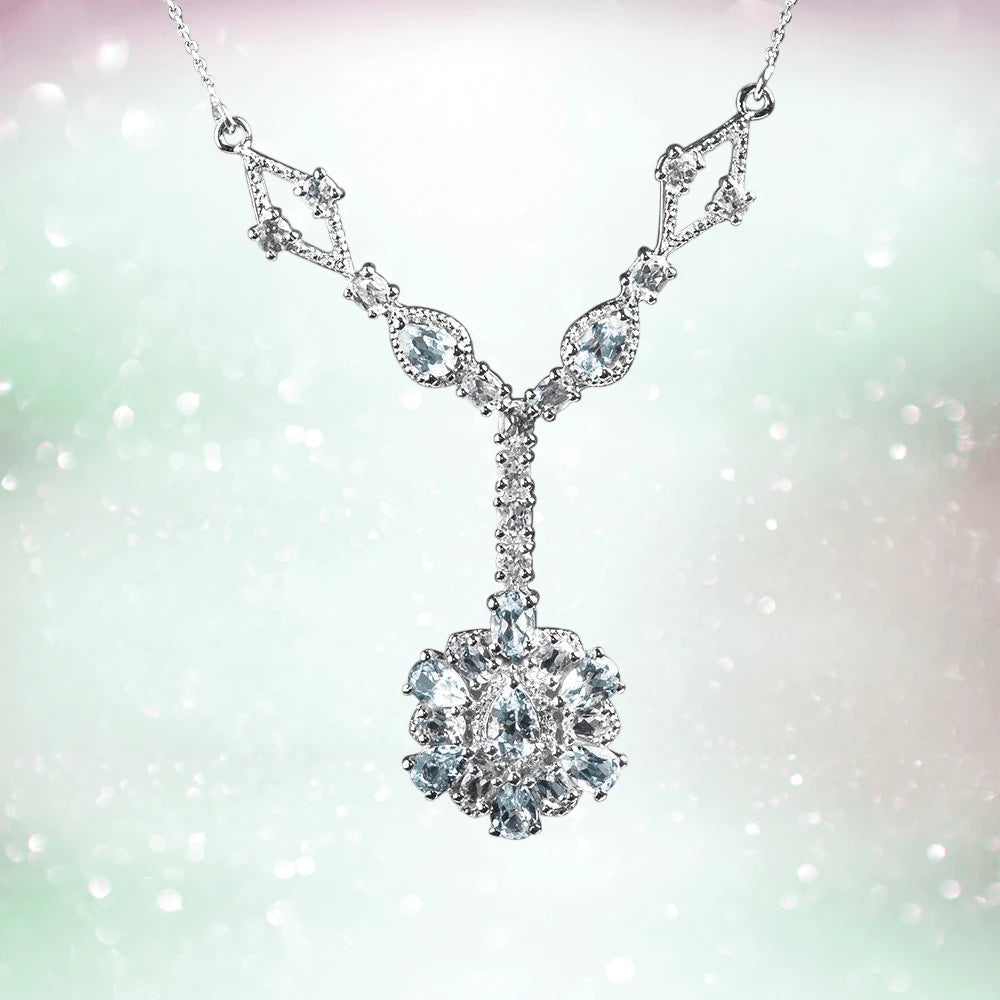 Bonita Topaz Necklace featuring a sterling silver chain with rhodium plating and an intricate pendant adorned with sparkling topaz gemstones, designed for women’s jewelry.