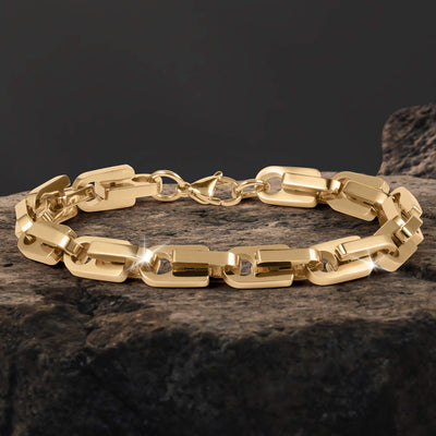 Moderna Link Bracelet with polished gold tone interlocking links and a secure clasp displayed on textured stone for a refined jewelry presentation