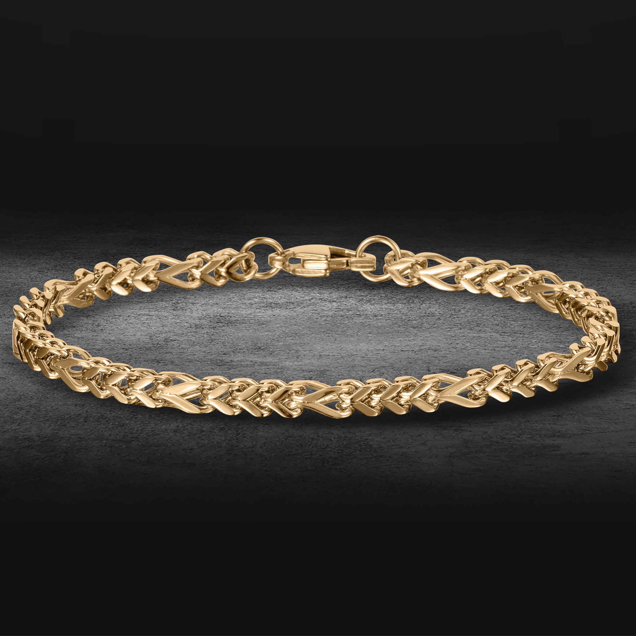 Kodiak Steel Collection gold braided chain bracelet with secure clasp on a dark background polished jewelry piece up to 75% off retail