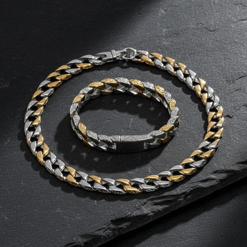 Two silver and gold chain necklaces on a dark surface. Curb Vine Men&
