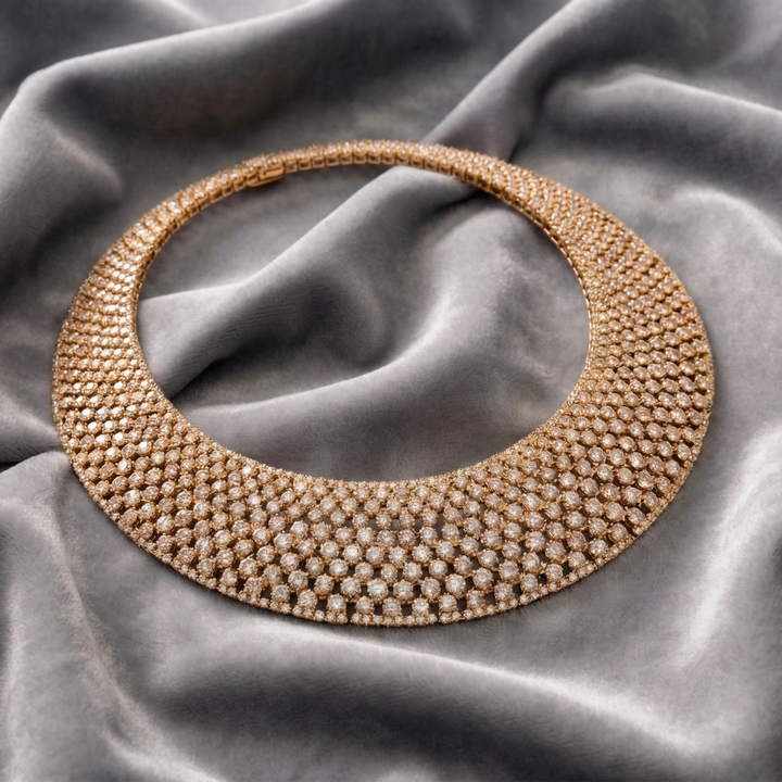 Gold necklace on a textured gray fabric background