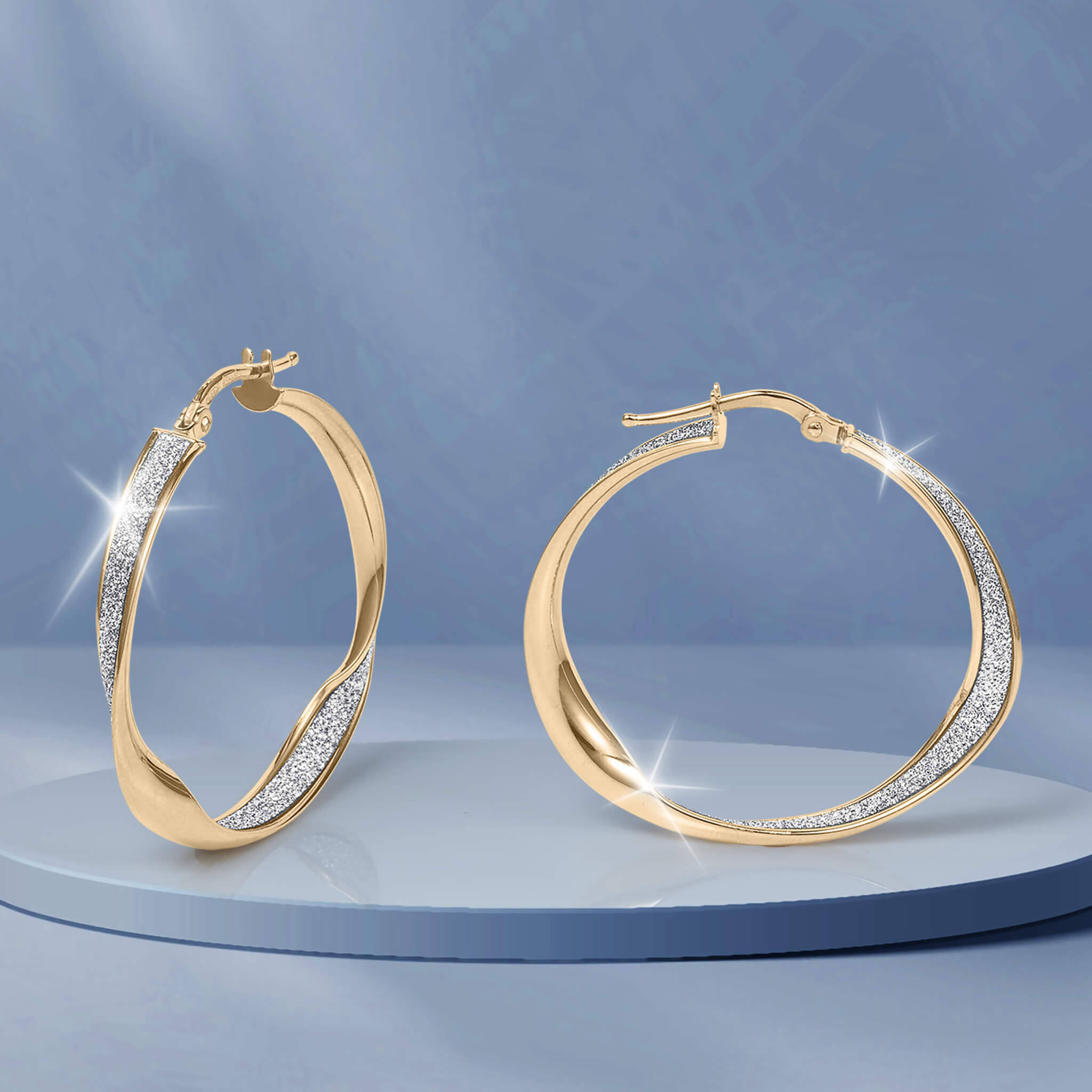 Serena Earrings gold hoop jewelry with sparkling pavé accents displayed on a blue pedestal for an elegant polished look and timeless style