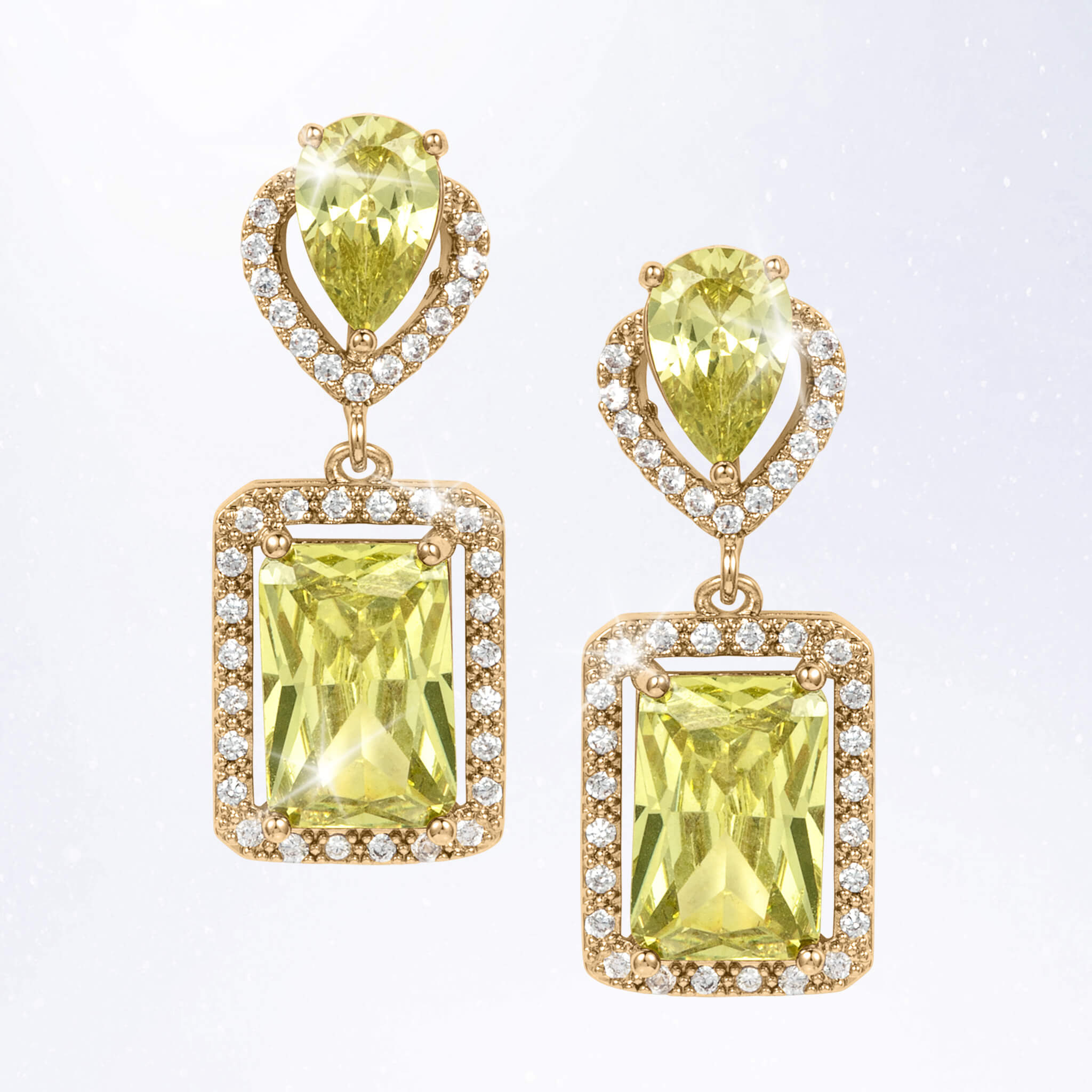 Pair of gold tone drop earrings featuring faceted yellow green gemstones framed by sparkling clear stones in rectangular settings