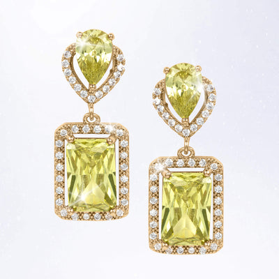 Pair of gold tone drop earrings featuring faceted yellow green gemstones framed by sparkling clear stones in rectangular settings