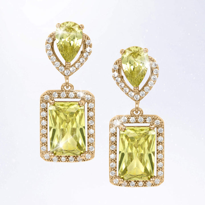 Pair of gold tone drop earrings featuring faceted yellow green gemstones framed by sparkling clear stones in rectangular settings