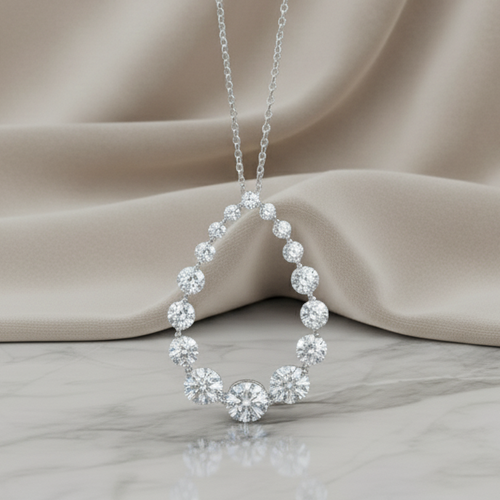 Silver necklace with a circular pendant on a beige fabric background. Daniel Steiger To Catch A Thief Pendant