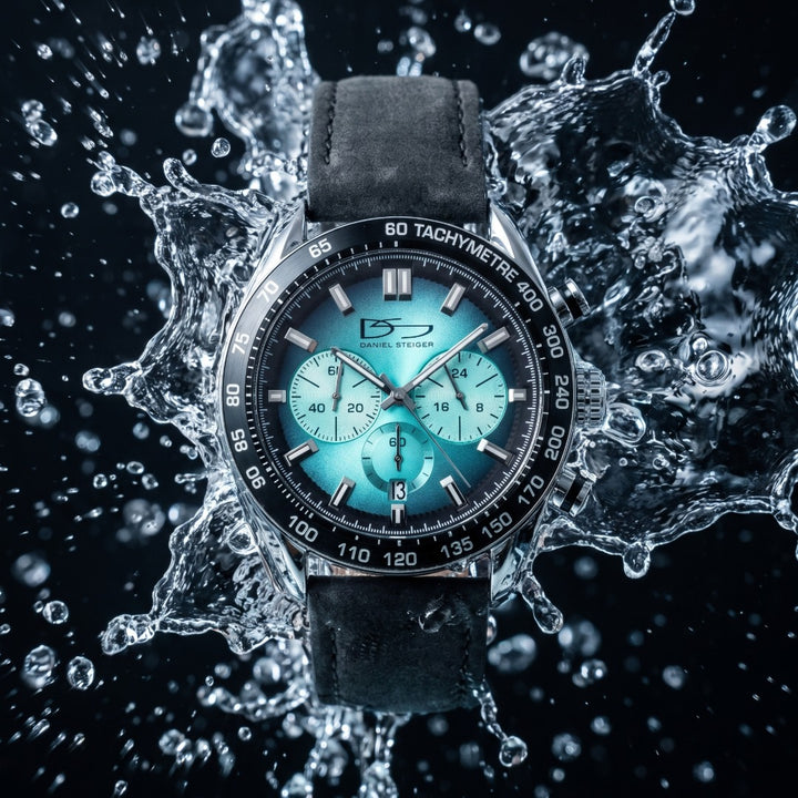 Hydrasteel Chrono Men's Watch with turquoise chronograph dial and black leather strap amid a dramatic water splash. Up To 75% Off Retail