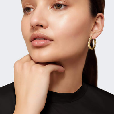 Woman wewaring gold earrings