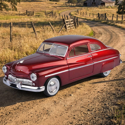 Vintage red car on a dirt road in a rural setting