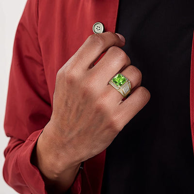 Gold ring with green stone on man's finger