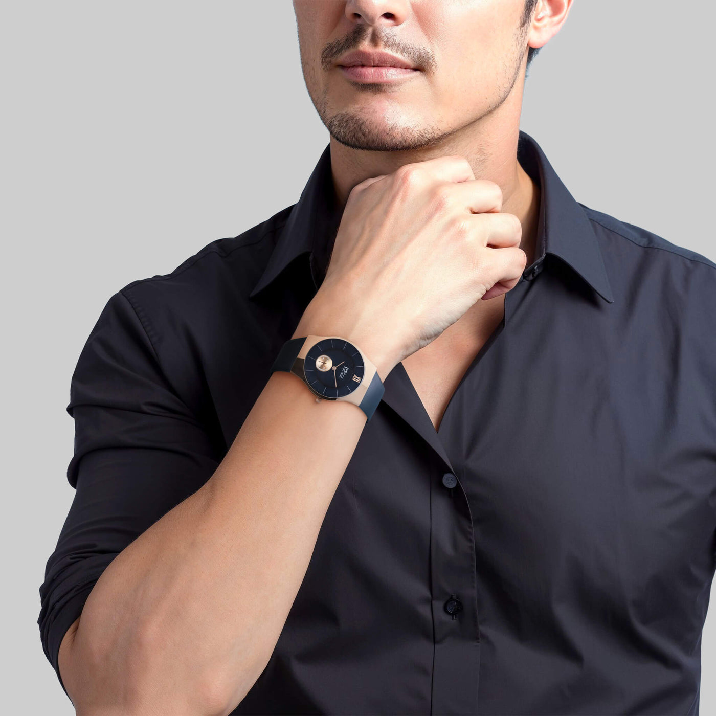 Man wearing blue and rose gold watch