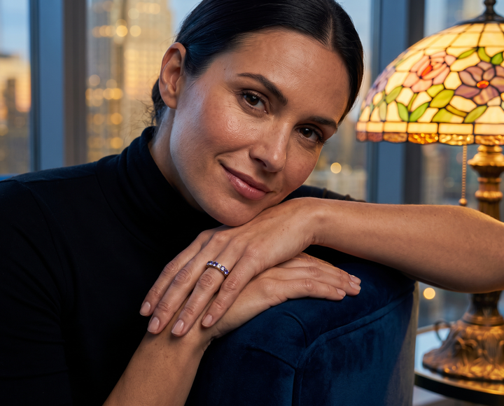 Milele Tanzanite Ring worn by a woman resting her hands on a chair in a warmly lit room Up To 75% Off Retail