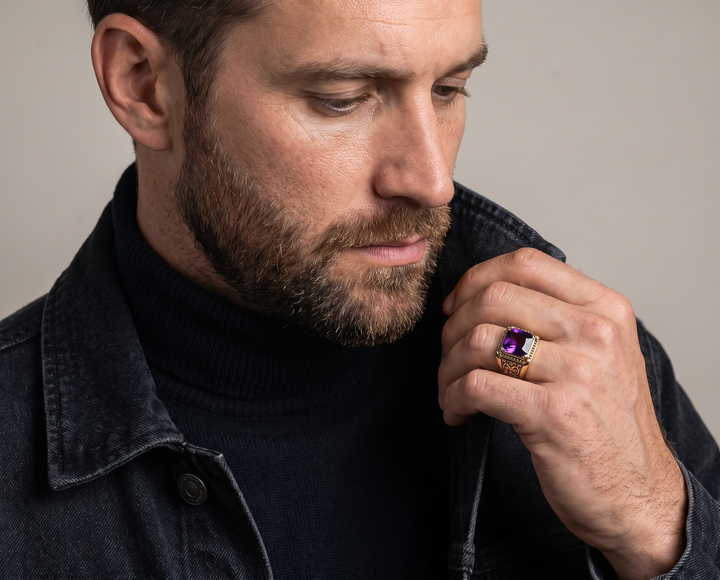 Augustus Purple Ring worn by a bearded man in a black turtleneck and denim jacket showing its vivid purple center and gold tone setting Up To 75% Off Retail