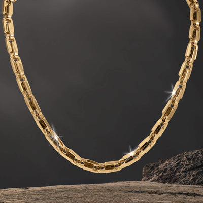 Moderna Link Collection gold tone link necklace with polished geometric links and sparkling accents displayed against a dark background