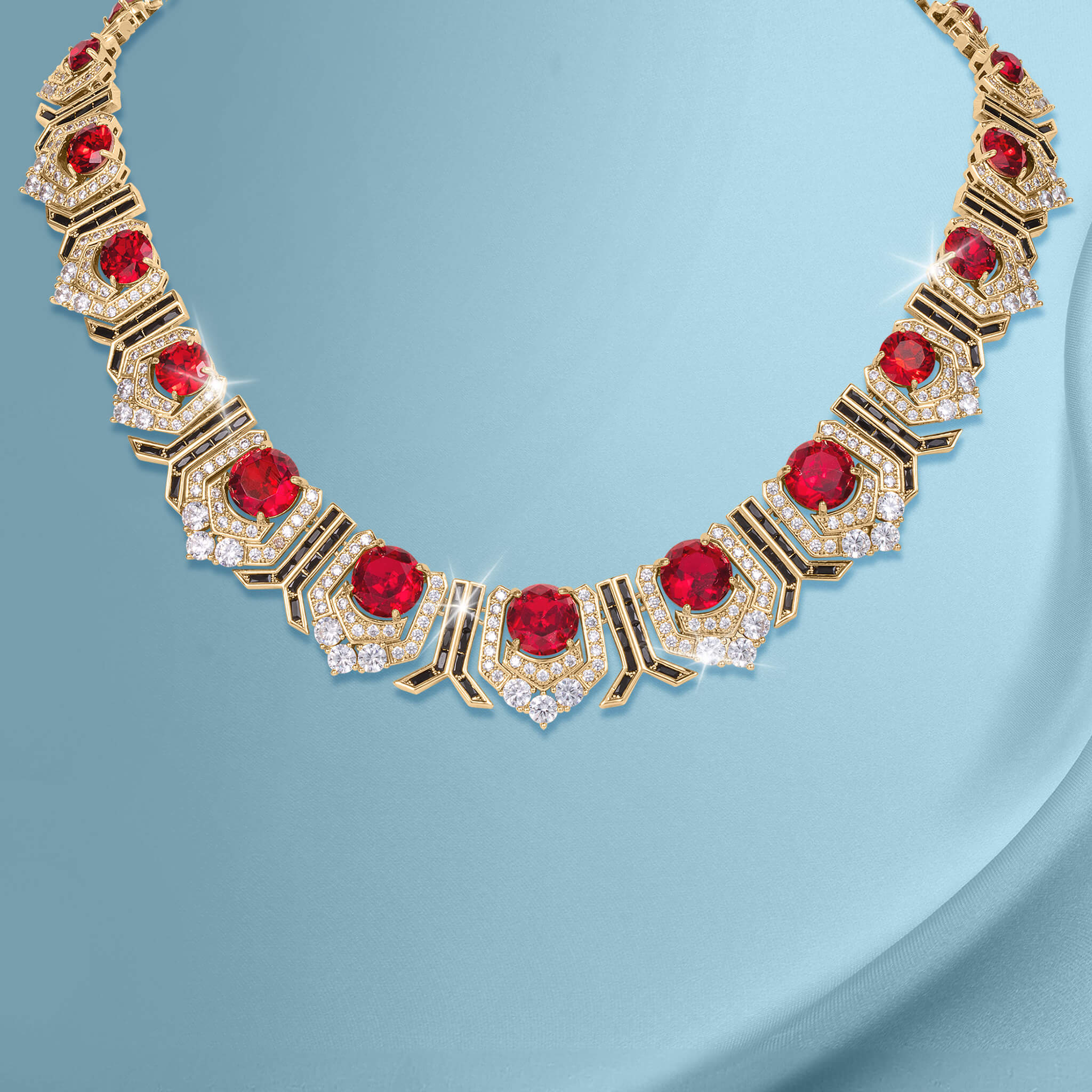 Elegant gold necklace from the Scarlet Heirloom Collection featuring vibrant red gemstones and sparkling crystals, available Up To 75% Off Retail.