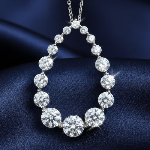 Diamond necklace on a dark blue fabric background. Daniel Steiger To Catch A Thief Pendant