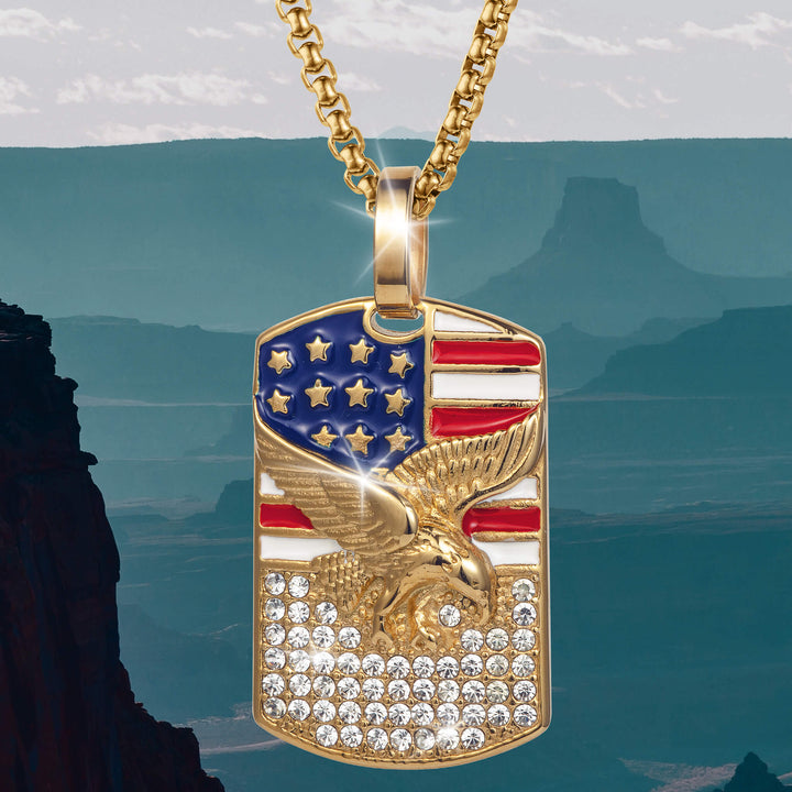Patriot’s Crest Pendant featuring a gold-tone eagle with outstretched wings over a U.S. flag design and sparkling clear stones on a matching gold chain necklace.