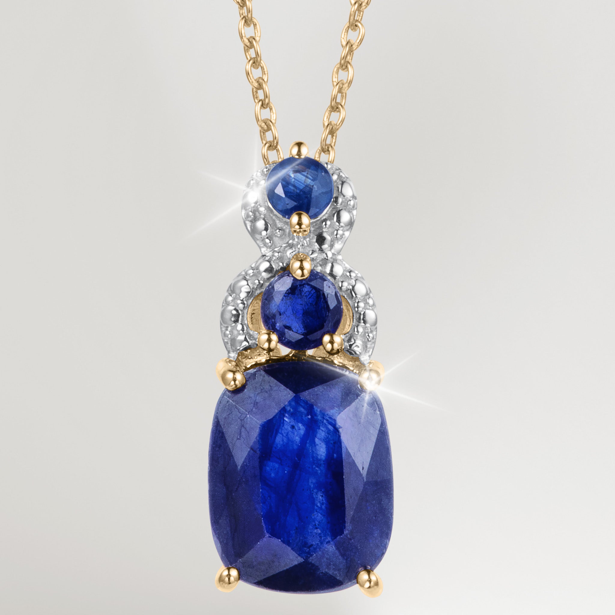 Elara Sapphire Pendant featuring faceted blue sapphire gemstones in a gold tone setting with sparkling accents on a delicate chain Up To 75% Off Retail